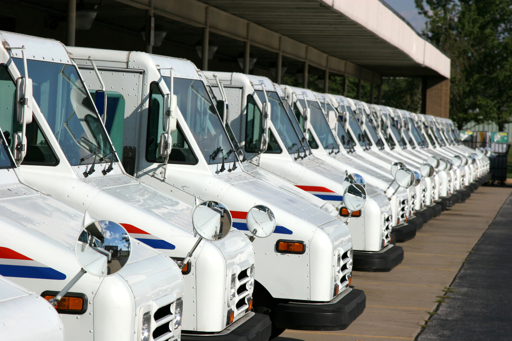 fleet of USPS delivery vans